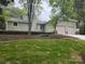 Charming home exterior with light green siding, a two-car garage, and a well-manicured lawn at 10912 Treebark Dr, Charlotte, NC 28226