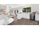 Bright eat-in kitchen features white cabinetry, granite countertops, stainless steel appliances and backyard access at 10912 Treebark Dr, Charlotte, NC 28226