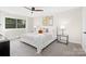 Main bedroom features a light color palette, ceiling fan, and large window for lots of natural light at 10912 Treebark Dr, Charlotte, NC 28226