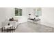 Bright office with a gray desk and lots of light near an upholstered accent chair at 10912 Treebark Dr, Charlotte, NC 28226