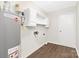 Utility room with water heater, cabinets, and LVP flooring at 10912 Treebark Dr, Charlotte, NC 28226