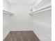 This empty walk-in closet has shelving, carpet and is ready for all your storage needs at 10912 Treebark Dr, Charlotte, NC 28226