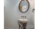 Elegant powder room with pedestal sink and ornate mirror at 115 Cloverhill Rd, Mooresville, NC 28117