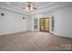 Spacious Primary bedroom with carpet flooring and access to a balcony at 115 Cloverhill Rd, Mooresville, NC 28117