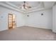 Large bedroom with carpet, ceiling fan, and access to the bathroom at 115 Cloverhill Rd, Mooresville, NC 28117