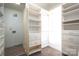 Spacious walk-in closet with built-in shelving and drawers at 115 Cloverhill Rd, Mooresville, NC 28117