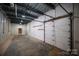 Spacious garage featuring overhead door and storage shelving at 115 Cloverhill Rd, Mooresville, NC 28117