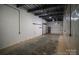 Unfinished garage with large overhead door and ample space at 115 Cloverhill Rd, Mooresville, NC 28117