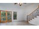 Bright and airy living room with sliding glass doors and staircase at 115 Cloverhill Rd, Mooresville, NC 28117