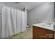 Full bathroom with shower/tub combo and wood vanity at 1208 Piedmont St, Charlotte, NC 28204