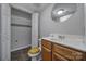 Clean bathroom with wood vanity, tile floor, and linen closet at 1208 Piedmont St, Charlotte, NC 28204