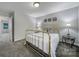 Spacious bedroom with brass bed frame and gray carpet at 1208 Piedmont St, Charlotte, NC 28204