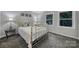 Cozy bedroom with brass bed frame, gray carpet, and ample natural light at 1208 Piedmont St, Charlotte, NC 28204