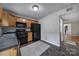 Kitchen with wood cabinets, black appliances, and tile floor at 1208 Piedmont St, Charlotte, NC 28204