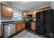 Modern kitchen featuring wood cabinets and black appliances at 1208 Piedmont St, Charlotte, NC 28204