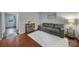 Living room with gray sofa, wood floors, and small table at 1208 Piedmont St, Charlotte, NC 28204