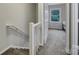 Upstairs hallway with white railing and carpet at 1208 Piedmont St, Charlotte, NC 28204