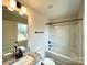 Well-lit bathroom featuring granite countertops, a large mirror, and shower-tub combo at 129 Sharon Rd, York, SC 29745