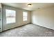 Bright bedroom with two windows and plush carpeting offers a cozy space at 129 Sharon Rd, York, SC 29745