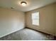 Bedroom with neutral walls, carpeted floor and a window providing natural light at 129 Sharon Rd, York, SC 29745