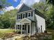 Charming two-story house with light gray siding, dark shutters, and covered porch at 129 Sharon Rd, York, SC 29745