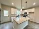 Island kitchen with white cabinets, granite countertops, and stainless steel appliances at 129 Sharon Rd, York, SC 29745