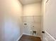 Practical laundry room with shelving and connections for laundry appliances at 129 Sharon Rd, York, SC 29745