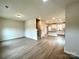 Open living room with light flooring and a view of the kitchen and staircase at 129 Sharon Rd, York, SC 29745