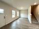 Bright living room featuring wood-look flooring and staircase access at 129 Sharon Rd, York, SC 29745