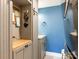 Small bathroom with light gray vanity and blue walls at 1408 Edgewater Dr, Charlotte, NC 28210