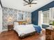 Bright bedroom with blue walls, wood floors, and a comfortable bed at 1408 Edgewater Dr, Charlotte, NC 28210