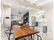 Open dining area with long wood table and view into kitchen at 1408 Edgewater Dr, Charlotte, NC 28210