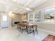 Dining room with marble floors, wood table and fireplace at 1408 Edgewater Dr, Charlotte, NC 28210