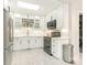 Modern white kitchen with stainless steel appliances and subway tile backsplash at 1408 Edgewater Dr, Charlotte, NC 28210