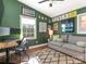 Home office with green walls, comfortable sofa, and workspace at 1408 Edgewater Dr, Charlotte, NC 28210