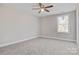 Well-lit bedroom with neutral carpeting and ceiling fan at 1443 Southwest Blvd, Newton, NC 28658