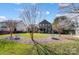 Spacious backyard with trees and two galvanized steel planters at 14818 Long Iron Dr, Huntersville, NC 28078