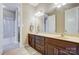 Double vanity bathroom with a shower/tub combo and updated features at 14818 Long Iron Dr, Huntersville, NC 28078