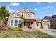 Two-story house with stone and shingle accents, two-car garage, and landscaped yard at 14818 Long Iron Dr, Huntersville, NC 28078