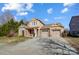 Two-story house with stone and shingle accents, two-car garage, and landscaped yard at 14818 Long Iron Dr, Huntersville, NC 28078