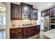 Well-equipped kitchen with stainless steel appliances and dark wood cabinets at 14818 Long Iron Dr, Huntersville, NC 28078