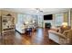 Bright living room featuring hardwood floors, fireplace, and ample natural light at 14818 Long Iron Dr, Huntersville, NC 28078