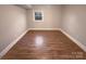 Simple bedroom with hardwood floors and a window at 1601 Lyndale Pl, Charlotte, NC 28210