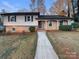 Brick ranch house with a landscaped yard and walkway at 1601 Lyndale Pl, Charlotte, NC 28210