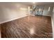 Large living room with hardwood floors, built-in shelving, and staircase at 1601 Lyndale Pl, Charlotte, NC 28210