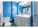 Full bathroom with white vanity and blue walls at 182 Water Oak Dr, Pineville, NC 28134