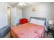 Bedroom with orange accent chair and coral bedding at 182 Water Oak Dr, Pineville, NC 28134