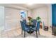 Dining area with four blue chairs and a view into kitchen at 182 Water Oak Dr, Pineville, NC 28134