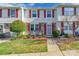 Brick townhouse with red shutters, front porch, and landscaping at 182 Water Oak Dr, Pineville, NC 28134