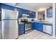 Blue cabinets, stainless steel appliances, and white tile backsplash at 182 Water Oak Dr, Pineville, NC 28134